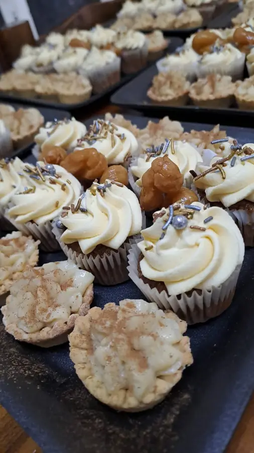 Frosted cupcakes and cinnamon mini milk tarts